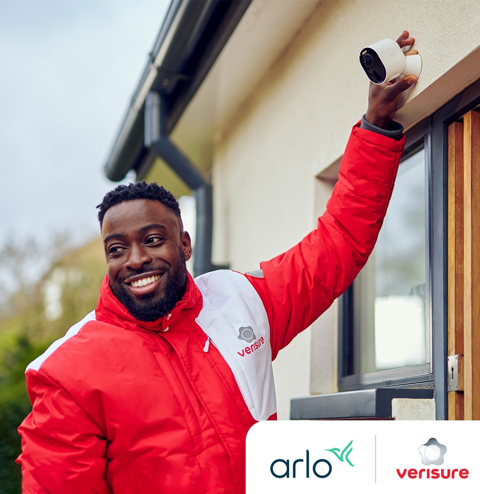 A Verisure installer checks the Arlo security camera in front of a customer's home