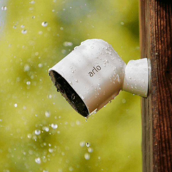 Arlo's Instagram post with an outdoor security camera set against a wall in the rain with a link on the post