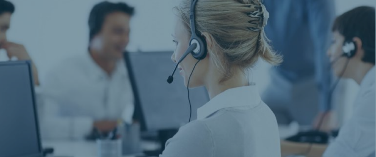 A woman in a customer service call center wearing a headset