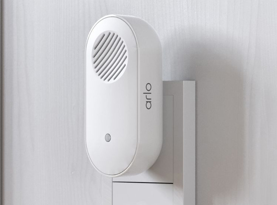 An Arlo wire-free video doorbell on a front door - designed to withstand the heat, cold, rain or sun.