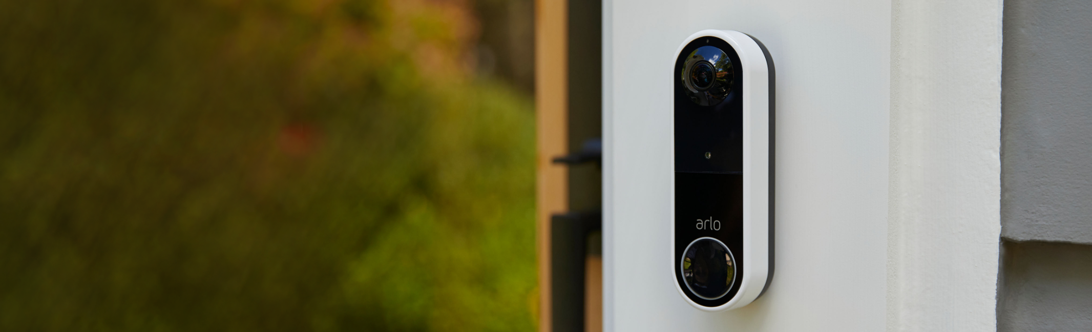 The Arlo video doorbell installed next to the front door of a house