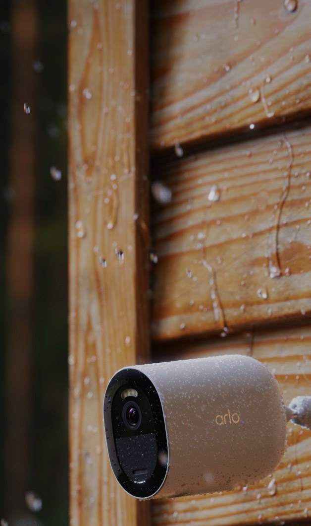 Arlo Go 2 camera mounted on side of cabin in rainy weather